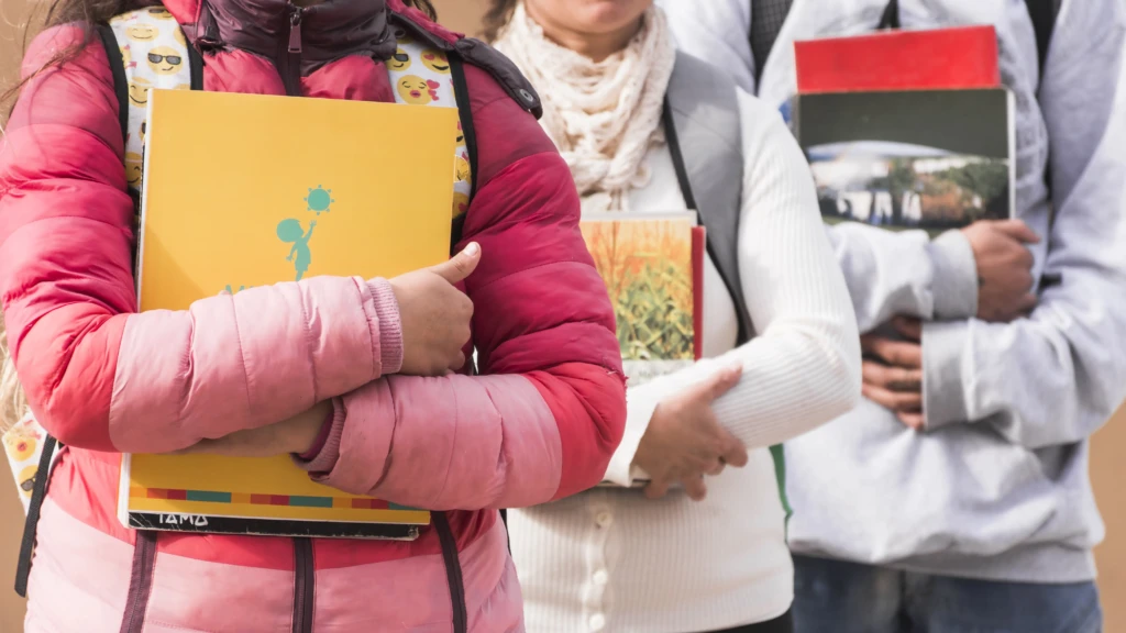 People holding notebooks and books, representing real field documentation for NGO and CSR annual report in India